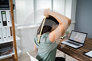 Woman Using Back Scratcher photo