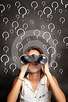 Young woman using binoculars