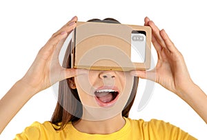 Young woman using cardboard virtual reality headset