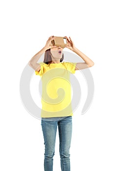 Young woman using cardboard virtual reality headset