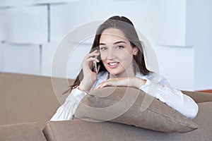 Young woman using cellphone at home