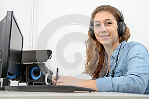 Young woman using computer for video editing