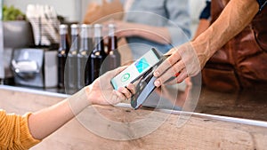 Young Woman is Using Contactless NFC Payment App Installed on Her Smartphone to Pay for Gourme Str