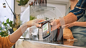 Young Woman is Using Contactless NFC Payment App Installed on Her Smartphone to Pay for Gourme Str