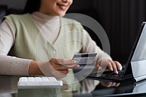 Young woman using credit card and tablet for buying online shopping at home , payment, buying and online shopping