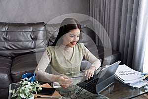 Young woman using credit card and tablet for buying online shopping at home , payment, buying and online shopping