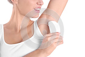Young woman using deodorant