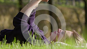 Young Woman using Digital E book on Grass in Nature