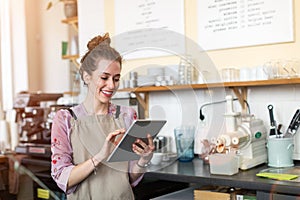 Young woman using digital tablet in coffee shop