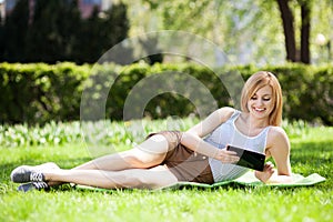 Young woman using digital tablet outdoors