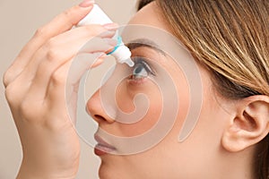 Young woman using eye drops, closeup