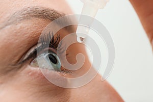 Young woman using eye drops, closeup