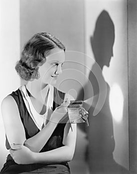 Young woman using a flashlight on her key chain