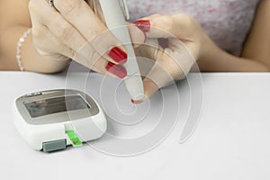 Young woman using a lancet