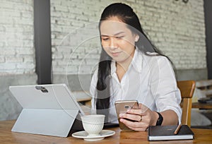 Young woman using laptop in cafe