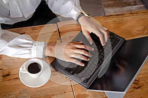 Young woman using laptop in cafe