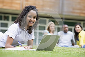 Young woman using laptop on campus