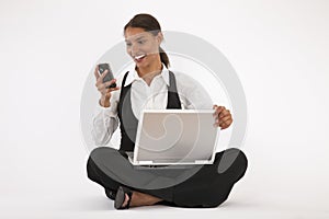 Young Woman Using Laptop and Cell Phone