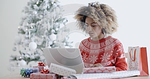 Young woman using a laptop at Christmas