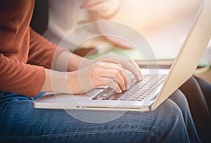 Young woman using laptop computer at outside office