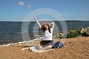 Young woman using laptop computer on sunbed on a beach. Freelance work concept, Freelancer outside