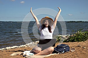 Young woman using laptop computer on sunbed on a beach. Freelance work concept, Freelancer outside