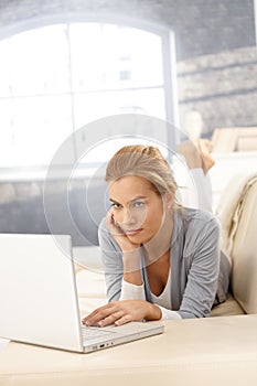 Young woman using laptop on couch