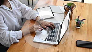 Young woman using laptop and digital tablet making online payment or shopping online.