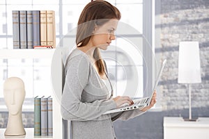 Young woman using laptop at home