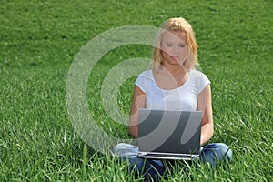 Young woman using laptop outside