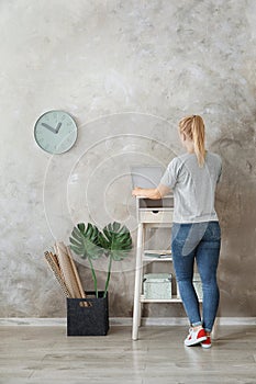 Young woman using laptop at stand up workplace