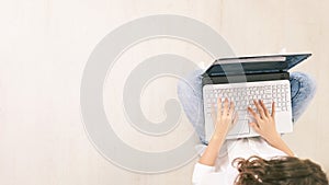 Young woman using laptop. Top view girl hands at computer keyboard. Lifestyle network technology. Creative education research.