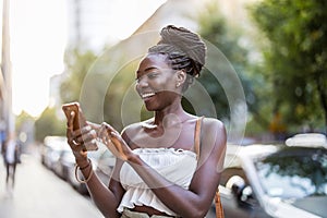 Young woman using mobile phone in the city