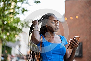 Young woman using mobile phone in the city