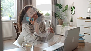 Young woman using mobile phone at home.