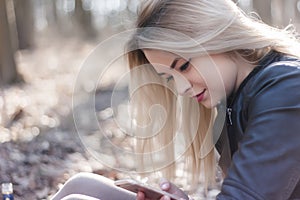 Young woman using mobile phone to searhing and reading news