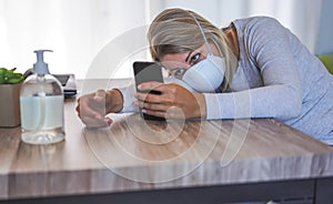 Young woman using mobile phone while wearing face mask for Covid 19 prevention - Isolation, technology and quarantine concept -