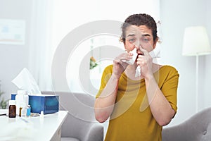 Young woman using nasal drops while following her doctors presription