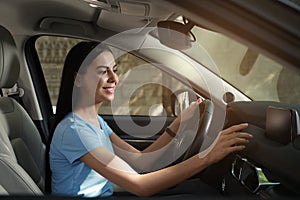 Young woman using navigation while driving car