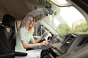 Young woman using navigation system while driving car