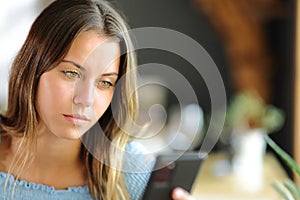 Young woman using smart phone in a restaurant
