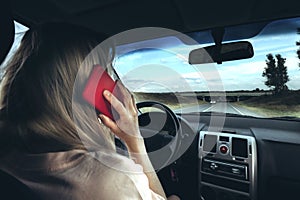 Woman using smartphone while driving car