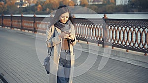Young Woman Using Smartphone. Girl reading on cell phone, using app, communicating in social media, texting.