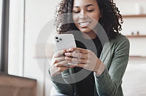 Young woman using smartphone at home. Student girl texting on mobile phone in her room. Communication, leisure lifestyle concept