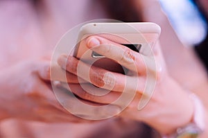 A young woman using an smartphone indoor