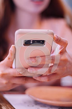 A young woman using an smartphone indoor