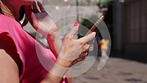 Young woman using smartphone on the street. Female, cellphone, chating.