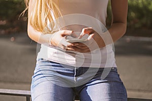 young woman using a smartphone on a sunny day in the city