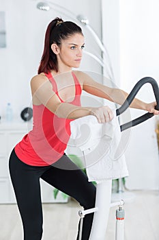 young woman using step exercise machine