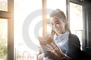 Young woman using tablet in coffee shop